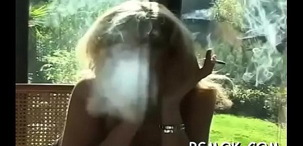  Excited babe playing with herself while enjoying a smoke